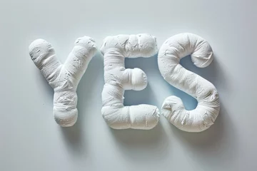 Gartenposter The word "YES" in a puffy, plush white texture against a clean background, giving a soft and positive impression. © evgenia_lo