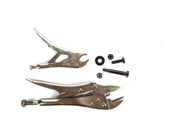 workshop handyman hand tools locking gripping pliers and nuts and bolts overhead view isolated on a...
