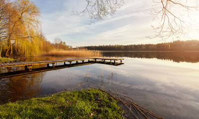 Scenic sunset with a pier on a lake near the town of Recz, West Pomeranian Voivodeship, Poland.