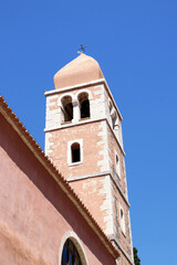 Fototapeta premium the lovely pink church in the old town of Rab, island Rab, Croatia