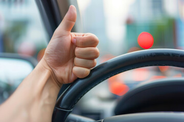 Thumb up sign inside car with city background