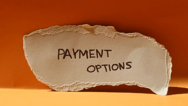 Payment options words written on ripped paper piece, closeup