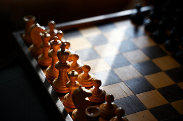 wooden chess pieces on an old board