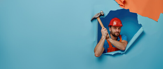 A focused handyman in a hard hat peers through a torn blue paper wall with a hammer in hand, as if listening in on a secret