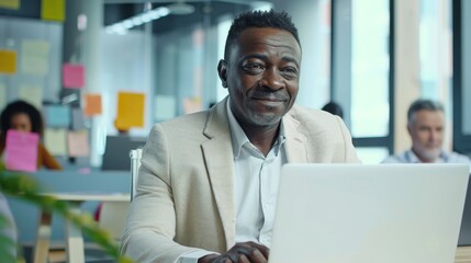 Fototapeta premium Smiling Man at His Laptop