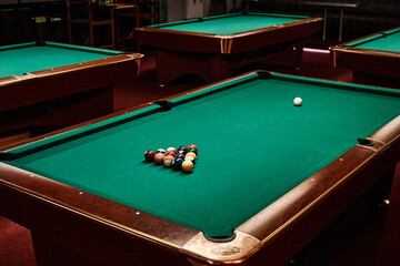 Background image of green pool table in low light with no people copy space