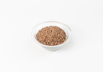 top view of lentils in a glass bowl on a white background