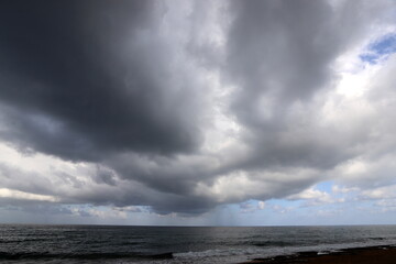 Rain clouds in the sky over the Mediterranean Sea.