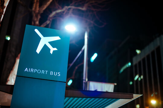 Airport bus sign at the bus stop on street at night