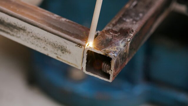Close-up of welding torch igniting
