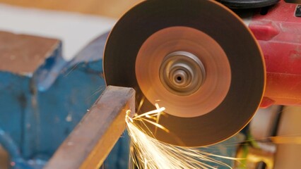 Close-up of sparks flying while grinding metal on a bench grinder