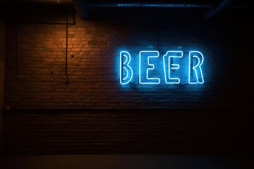 Vintage Beer Neon Sign on Dark Brick Wall Generative AI