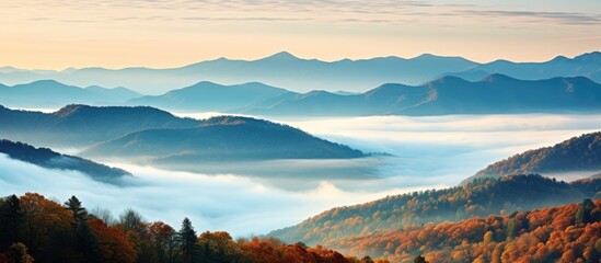Fototapeta premium Mountain peaks shrouded in autumn mist