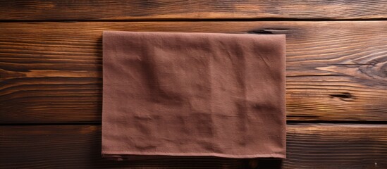 Brown napkin on wooden table with background