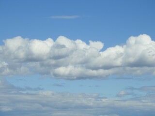Cloudscape, puffy clouds in a blue sky over the Bombay Hook National Wildlife Refuge, Kent County, Delaware.
