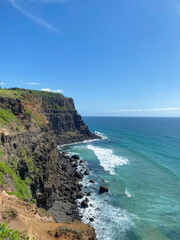 Horizontal photo of beautiful coastline in Hawaii with rocky coast and nice sky