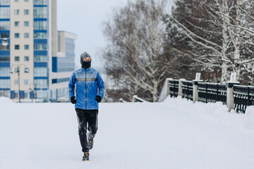 adult man runs along path