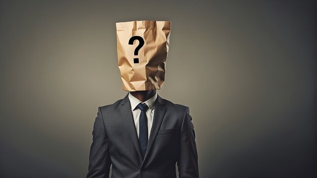 Businessman with a question mark concept and a paper bag on his head