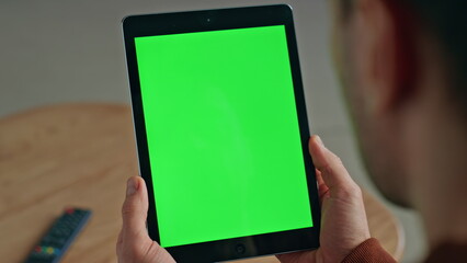 Unknown man watching chroma key tablet at desk closeup. Student holding device