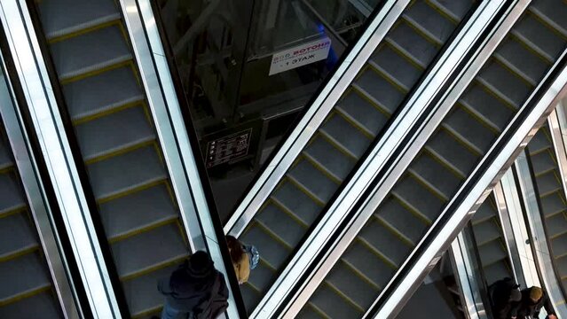 Escalators in the mall with people. Saint Petersburg, Russia - 12 April 2024. 4k video.