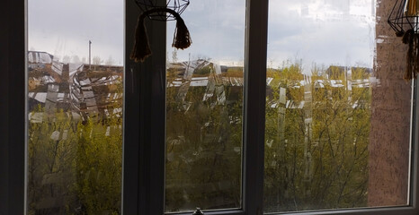 Windows sealed with tape, war in Ukraine. Seal the windows with tape from the blast wave with a...
