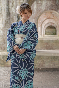Pretty Japanese woman posing in old archway.
Portrait of a model wearing a nice kimono.
