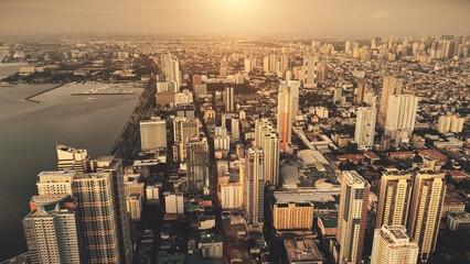 Metropolis city at sea bay sunrise aerial. Philippines capital cityscape at sun rise light. Urban...