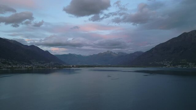 Majestic view on Swiss lake surrounded by amazing mountains with valleys and villages shooting by drone. High quality 4k footage