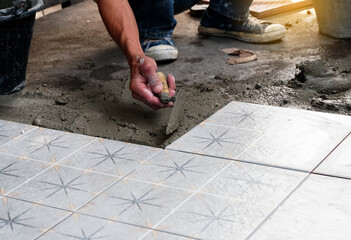 Floor tiles installation. Ceramic tiles and tools for tiler. Home improvement, renovation - ceramic...