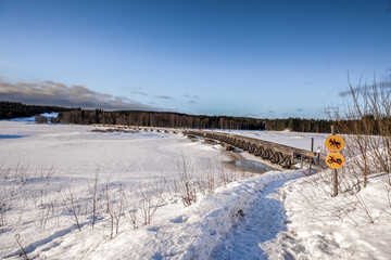 Wooden pedestrian bridge in the Storvorsen nature reserve in Swedish Lapland