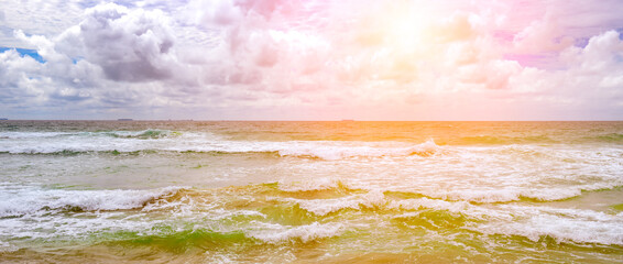 Bright sunrise over ocean waves.