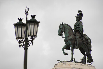 Fototapeta na wymiar Public lamp in the city of Lisbon with statue of the knight D.Jose