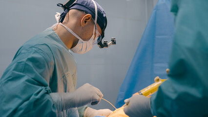 Doctor man physician surgeon perform plastic surgery liposuction surgical laparoscopic abdominal...