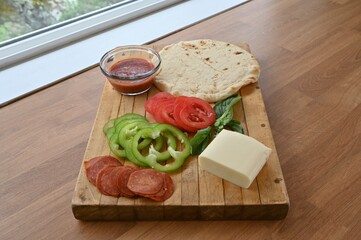 Simple homemade naan bread pizza with healthy fresh ingredients for date night dinner at home