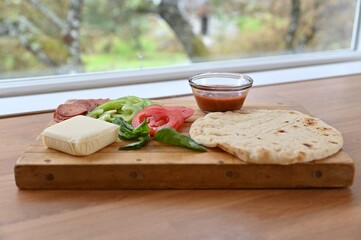 Simple homemade naan bread pizza with healthy fresh ingredients for date night dinner at home