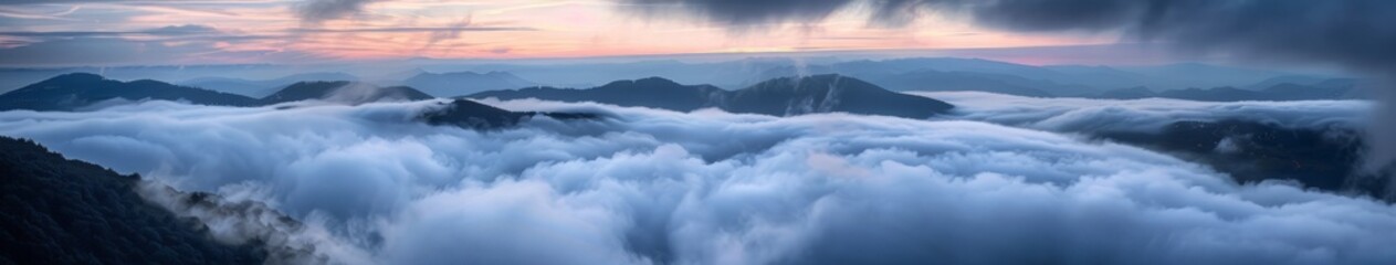 Naklejka premium mountain peaks above the clouds.