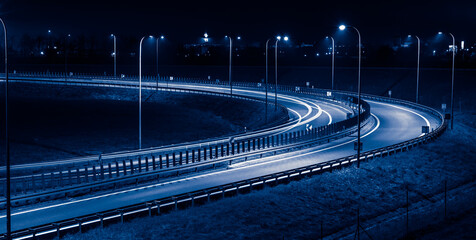 sharp bend of the road, long exposure of car lights at night