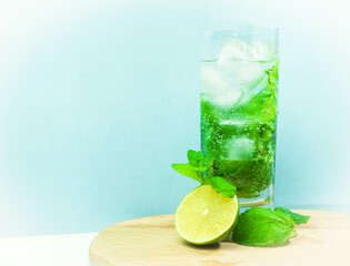 Fresh cocktail vitamin mojito with mint. Summer natural drink with lime fruit. Soda in a transparent glass. Alcoholic drink Apperol. Natural juice with ice.