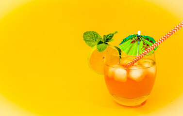Summer fresh with a straw on a bright orange background. Alcoholic drink bar. Space copy. Fresh juice with solid color background. Natural juice with ice.