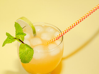 Lemonade with a straw in a glass. Summer drink orange with mint with ice. Soda in a transparent glass. Apperol alcoholic drink, Apperol with mint and lime top view