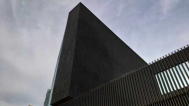 Hong Kong - 08.29.2021: Close-up of the exterior of Mplus museum under a cloudy grey sky during the pandemic