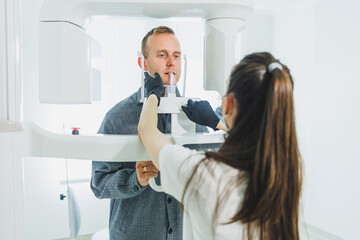 A young man underwent a CT scan of the jaw, a circular image of the jaw in modern dentistry. Radiology, panoramic scanner.