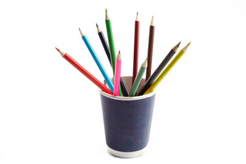 a paper cup full of colorful pencil crayons isolated on white