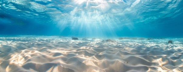 Serene underwater sunrays over sandy ocean floor - obrazy, fototapety, plakaty