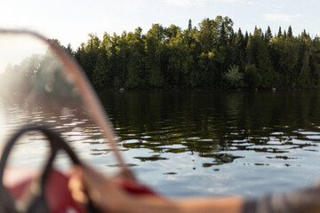 Lake, forest and reflections on the water from the point of view of someone driving a boat - obrazy, fototapety, plakaty