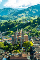 Aerial view of the brick church of Jerico, Antioquia, Colombia. Blue sky and the Andes Mountains in...