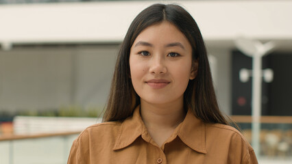 Close up business portrait Asian ethnic girl beautiful calm chinese korean japanese woman looking...