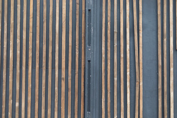 Wall of a building made of boards. House details. Wall with vertical lines.