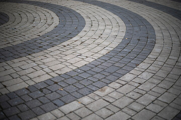 Tiles on the square. The paving stones lie in a circle. Area details.