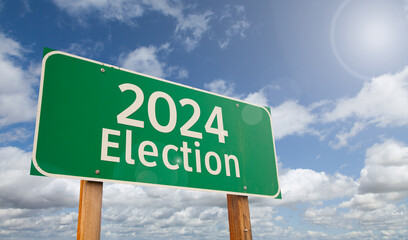 2024 Election Just Ahead Green Road Sign Over Clouds and Blue Sky. - 782495893